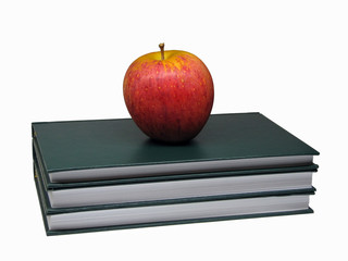 Red apple above three green hardcover books
