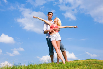 Young love couple having fun on spring meadow