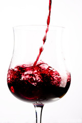 red wine splashing in a glass