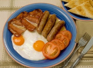 Breakfast on plate with toast.