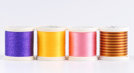 Four bobbins of sewing