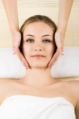 beauty portrait of a young woman getting a massage