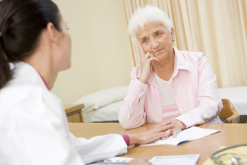Woman in doctor's office frowning
