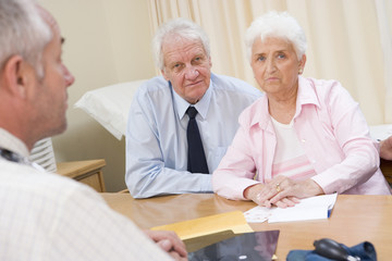 Couple in doctor's office frowning