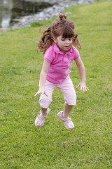 girl jumping in grass