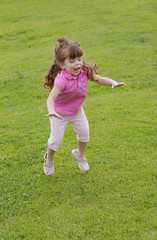 girl jumping in grass