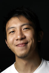 Fototapeta premium Happy smiling asian teen with black background