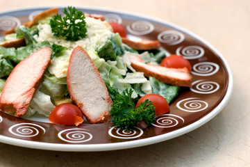 Lunch plate of Caesar salad with grilled chicken in cafe