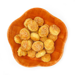Baked biscuits with cheese, butter and sesame in wooden dish