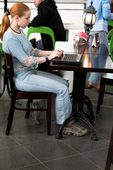 girl with computer in cafe