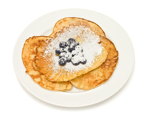 Pancakes with blueberries on white background