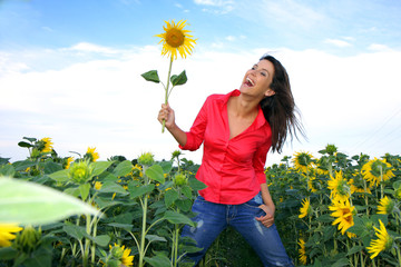 peaceful red dressed girl in sunflower field