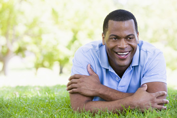 Naklejka na ściany i meble Man lying outdoors smiling