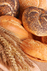 Fresh baked goods with ear of wheat on the table