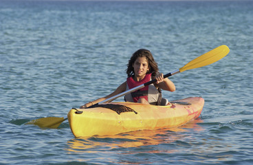young girl learning to kayaking