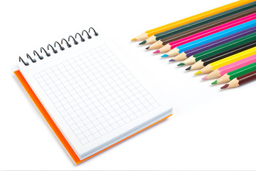Fototapeta na wymiar Blank notebook and coloured pencils