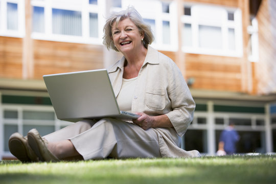 Senior woman using laptop on campus