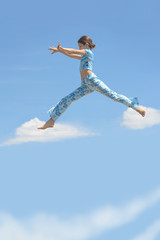 Beauty girl jump on sky clouds