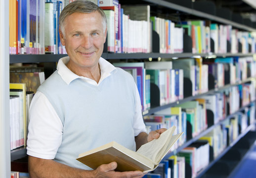 Senior Man Reading In A Library