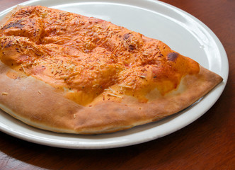 Delicious hot Calzone pizza  On a plate