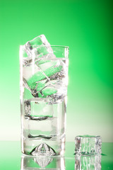 Tall iced drink backlit on green