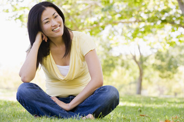 Woman sitting outdoors smiling