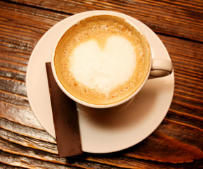Coffee cup with milk and heart shape