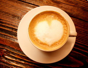 Coffee cup with milk and heart shape