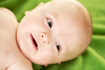 Up Close of cute baby face on green background