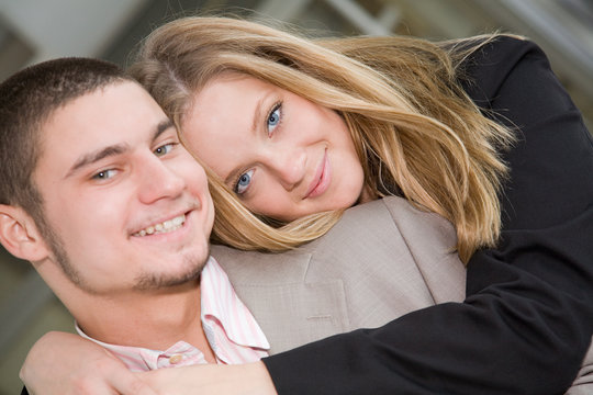 A beautiful blue-eyed blonde hugging a smiling man