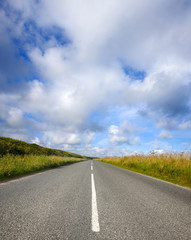 An empty English countryside road and a big sky in Cornwall.