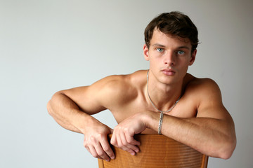 Obraz premium Sexy Man on the Chair. Copy Space