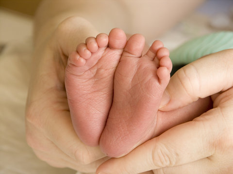 Mother holding her child's feet