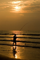 Fisherman Silhouettted in a Beach Sunrise