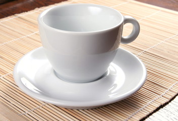 white cup on bamboo background