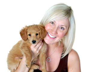 Portrait of a beautiful blond girl holding her beautiful puppy
