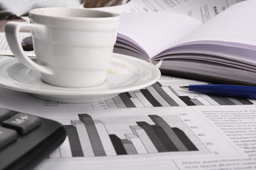 Cup of fragrant coffee on a morning paper business news