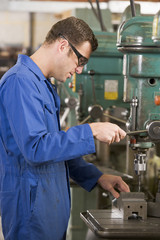 Machinist working on machine