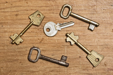 Assorted od keys on a wooden table.