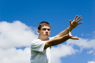 Young man on a background blue sky.