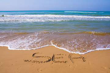 beautiful exotic beach in Mediterranean with a sign