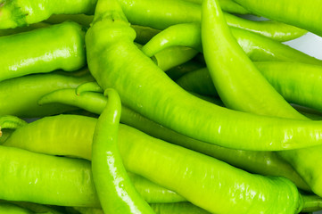 Green peppers in the plate isolated on white