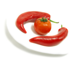 Two peppers, one single tomato