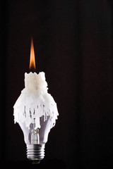 Lightbulb and burning candle