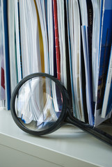 Brochures and Magnifing glass