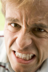 Head shot of man scowling