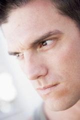 Head shot of man scowling