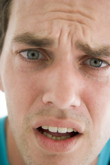 Head shot of man scowling