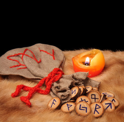 Runes, pouch and candle with copy space