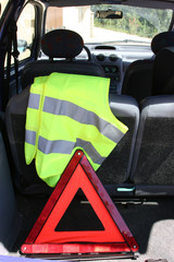 warning triangle and yellow waistcoat in the car